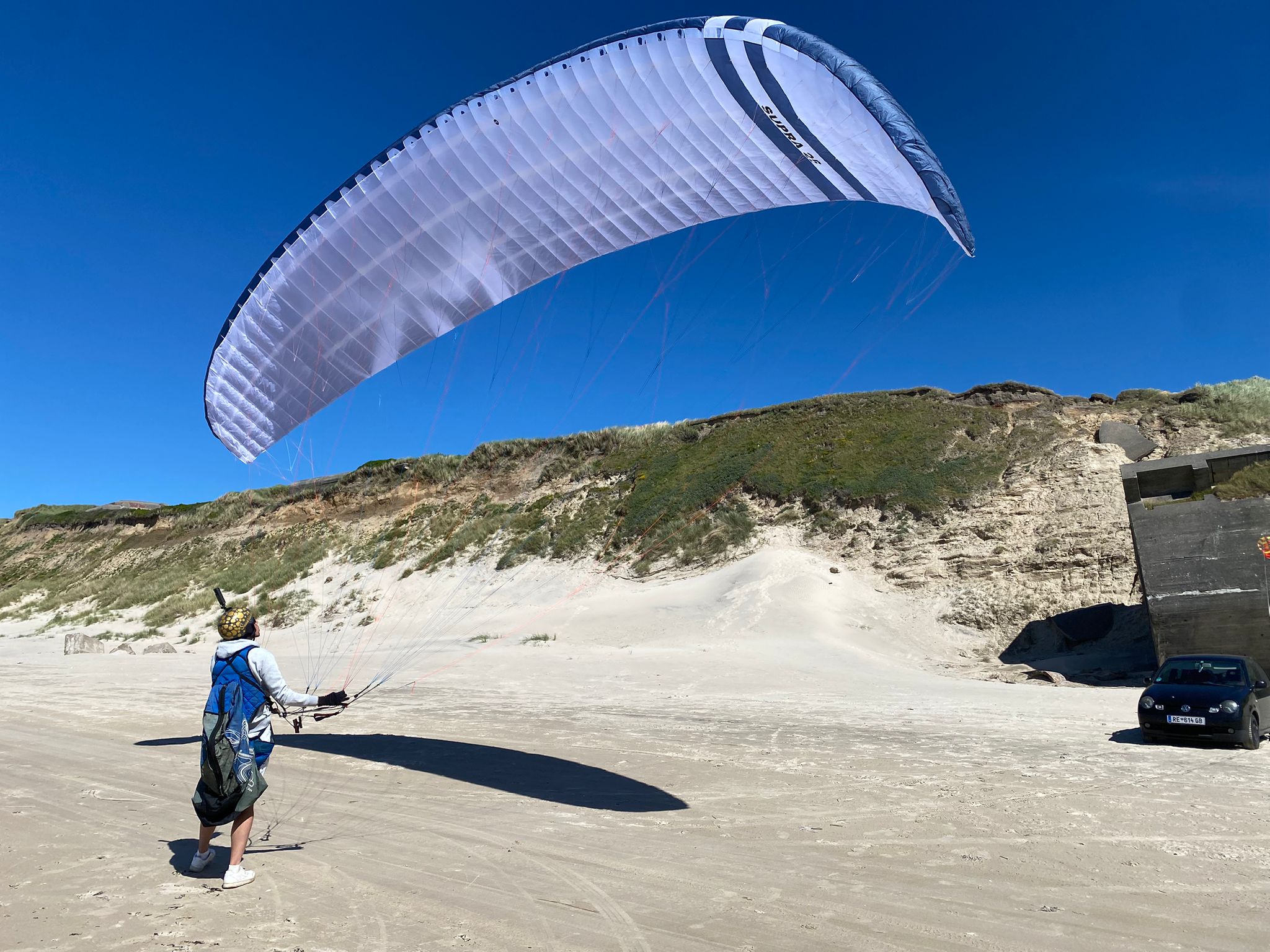 Pilot with a white SUPRA on the beach